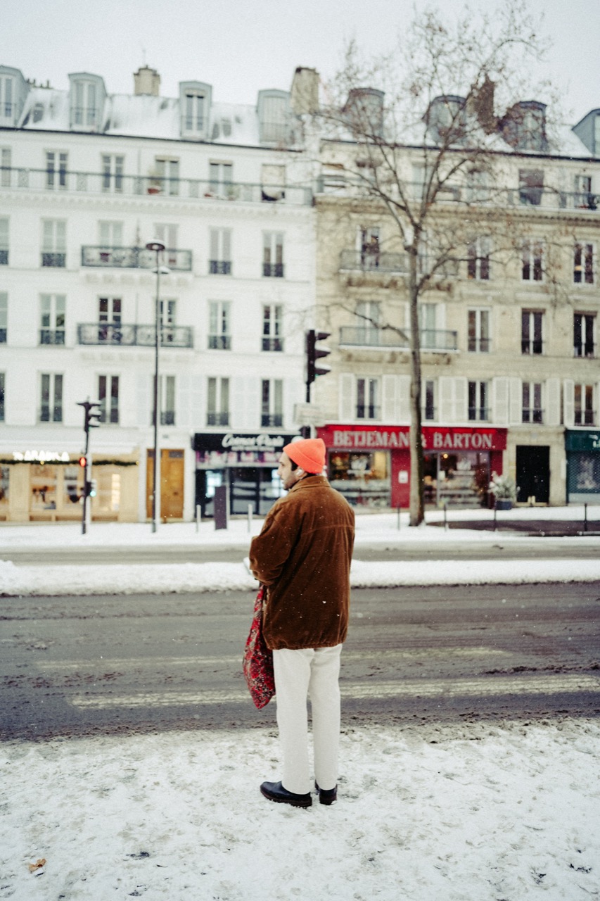 Figure in orange hat on a Paris street