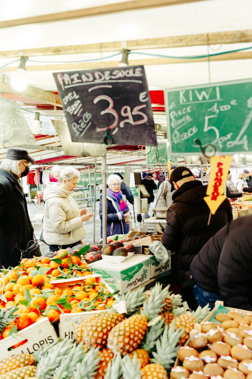 March&eacute; fruit stall with pineapples and oranges