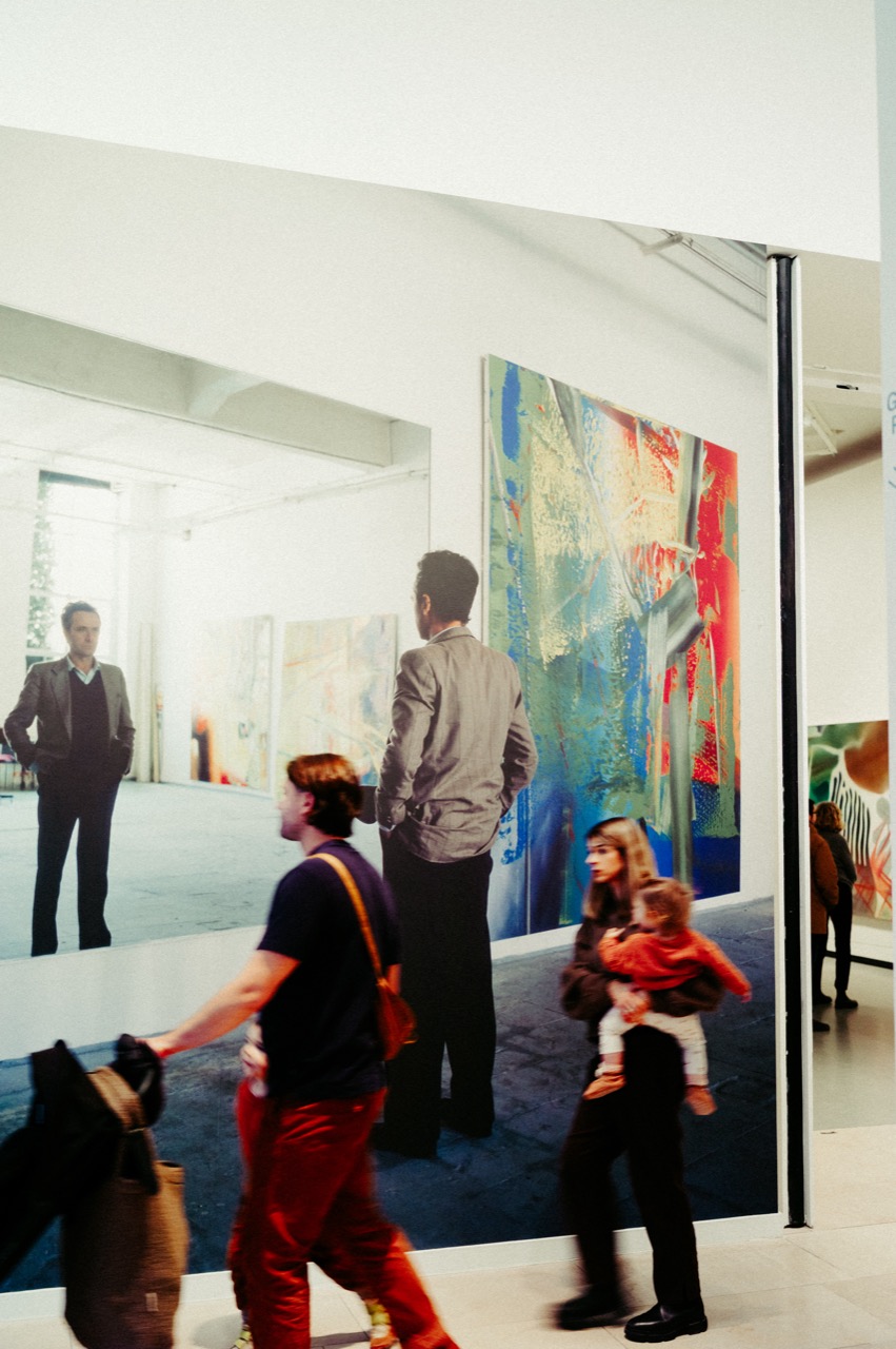 Richter exhibition room with mirror, viewers and artwork and reflections layered