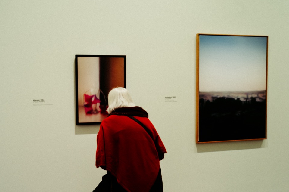 Red-shawled woman viewing art