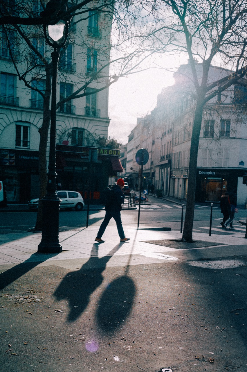 Silhouette crossing a street in backlight